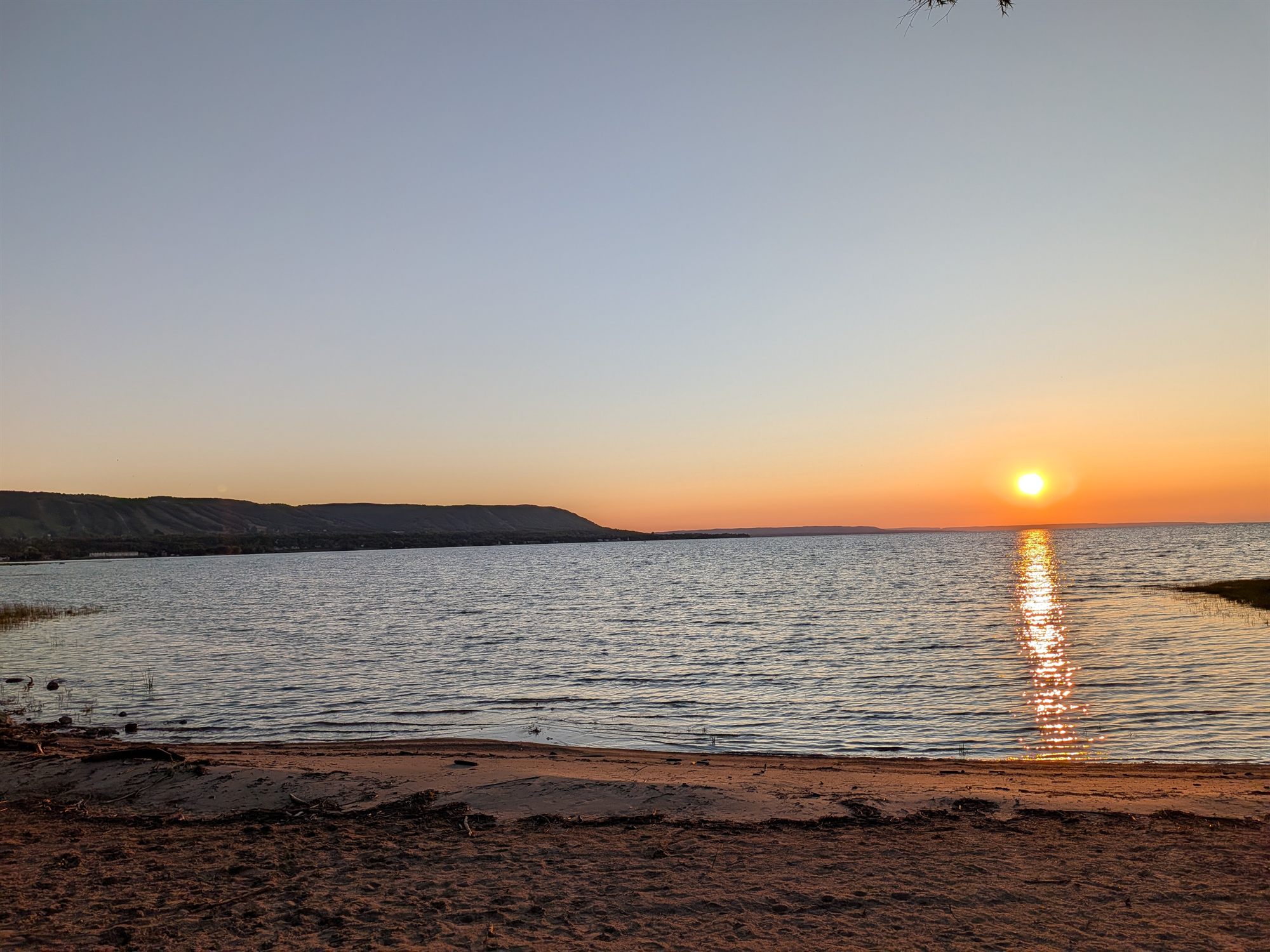 Sunset over Georgian Bay from the private sandy beach, the escarpment in silhouette